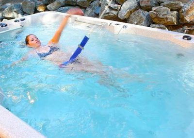 A woman swimming in the swim spa